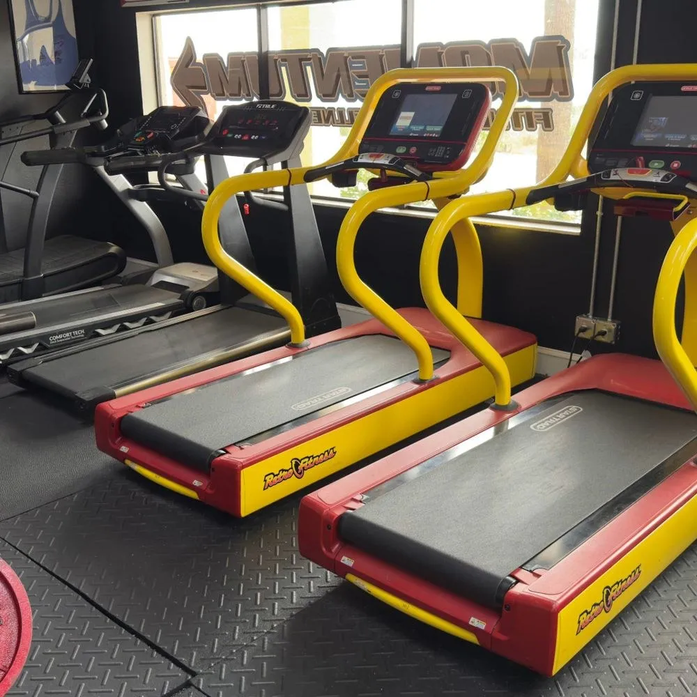 A row of treadmills by the front windows at Momentum